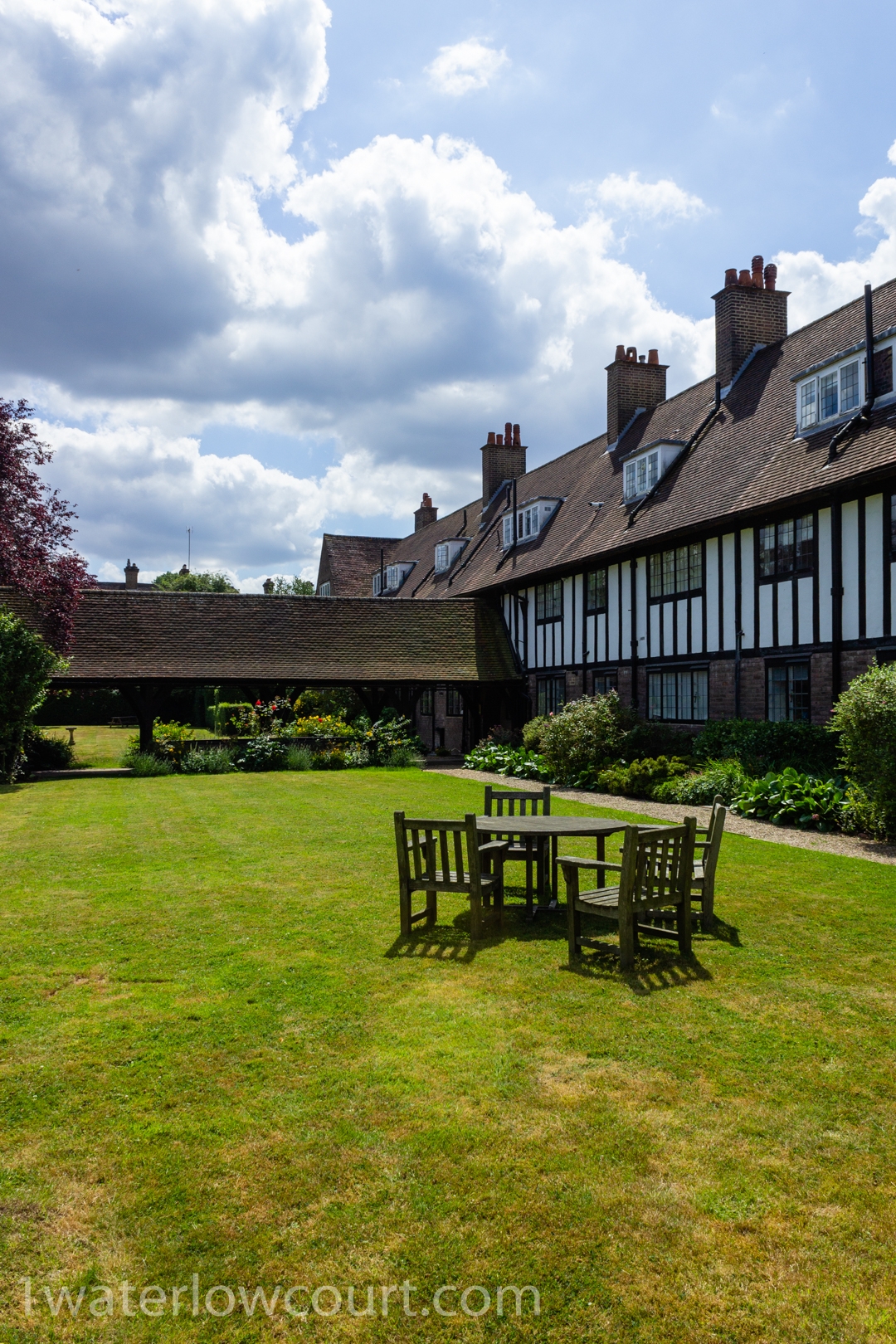 North-east garden of Waterlow Court, an Arts & Crafts Grade II* listed building, Hampstead Garden Suburb, London NW11 7DT. Flat 1 is a one-bedroom, ground-floor flat, and is for sale. Listed on Rightmove and Zoopla.